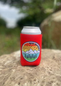 tangerine koozie with gtf outside logo. gtfo. sunrise logo with sun, mountains and trees