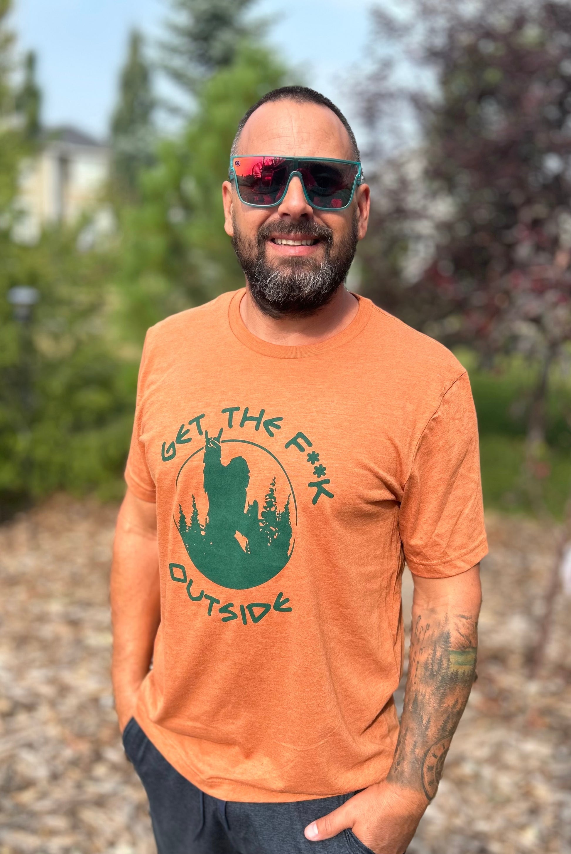 Rust Orange t shirt with a forest green logo of our sasquatch