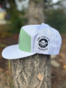 hat flat brim 5 panel, white with mind green front panel and silicone patch with mountain scene logo. Be Bold embroidery logo on the side, GTF Outside embroidered on the back
