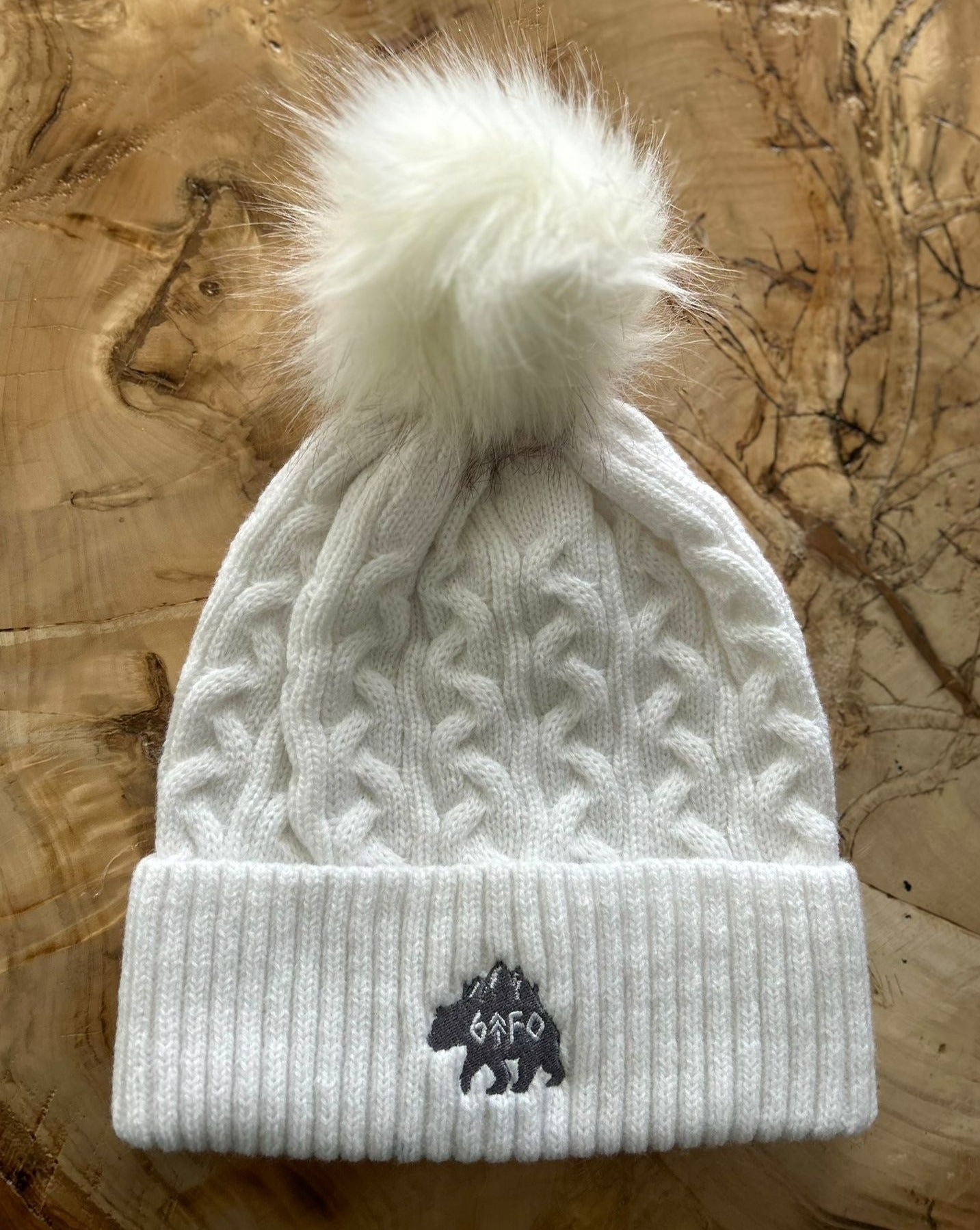 white pom pom toque with grizzly logo. gtf outside. gtfo