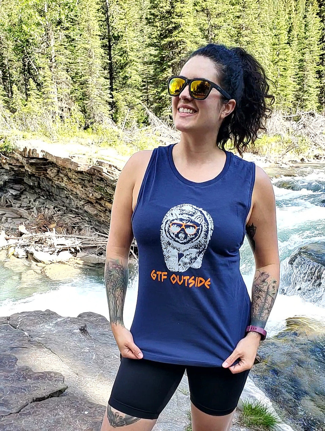 ladies navy tank with orange gtf outside logo with white bear wearing orange sunglasses. gtfo. womens tank