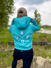 Load image into Gallery viewer, glacier blue ladies crop hoodie with white gtfo logo. gtf outside. finger holes.
