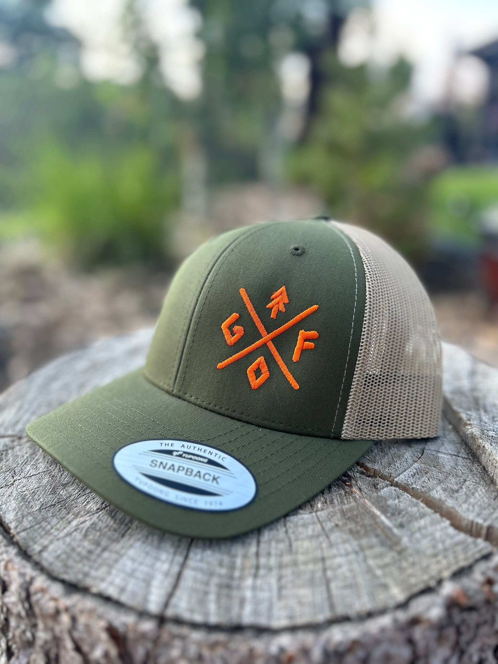 olive green hat with tan mesh with orange gtfo embroidered logo. gtf outside