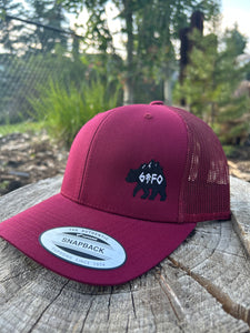 burgundy mesh hat with embroidered bear with mountains gtfo logo. gtf outside