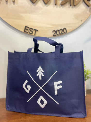 blue tote bag with white gtfo logo. gtf outside.